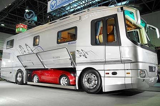Illustration for article titled Luxury Caravan Has Sports Car Parking Dock In Its Belly